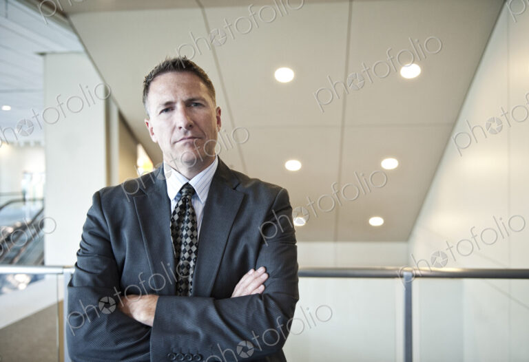 Portrait of a caucasian businessman in a convention center space.