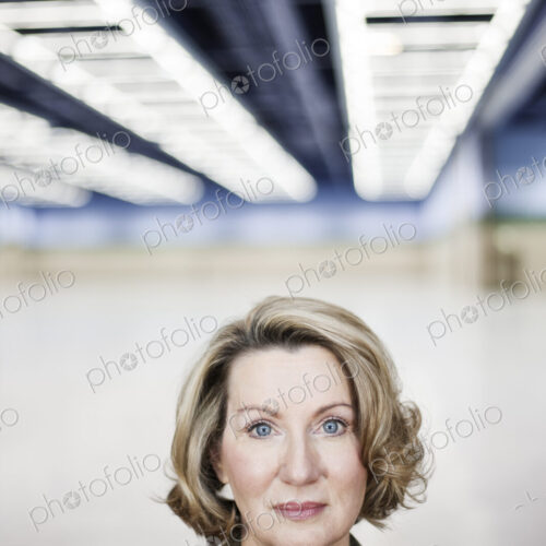 Portrait of a caucasian businesswoman in a convention center space.