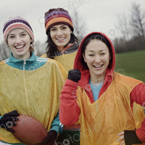 Portrait of a group of three women friends playing American Flag Football. Portrait of a group of three women friends playing American Flag Football.