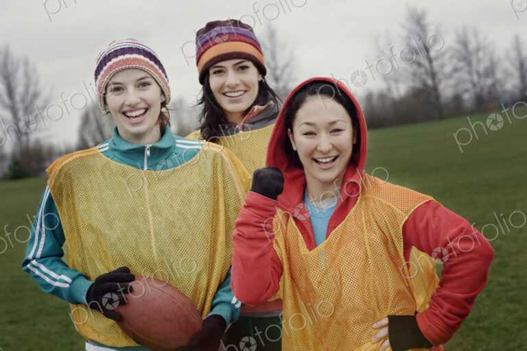 Portrait of a group of three women friends playing American Flag Football.