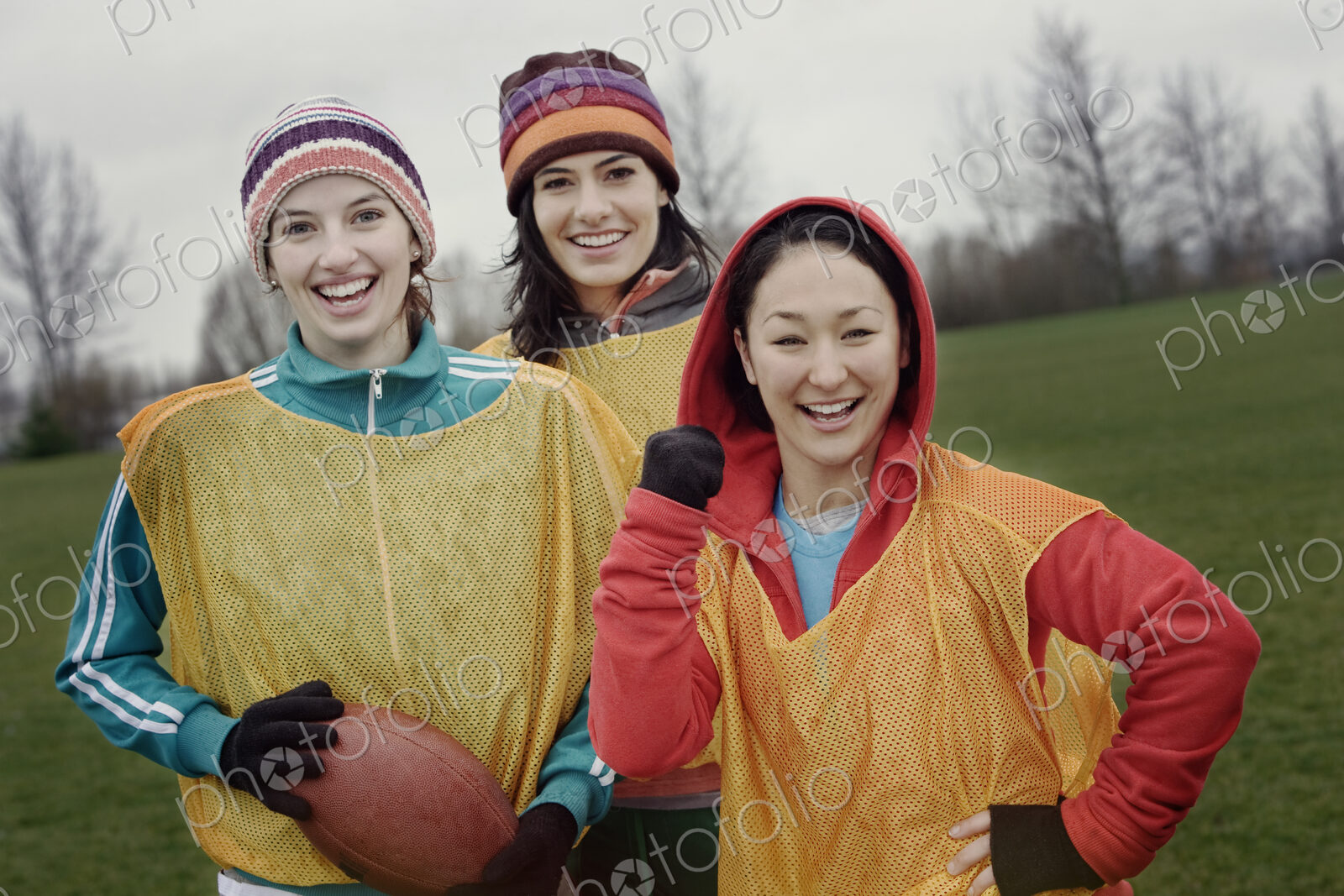Portrait of a group of three women friends playing American Flag Football.