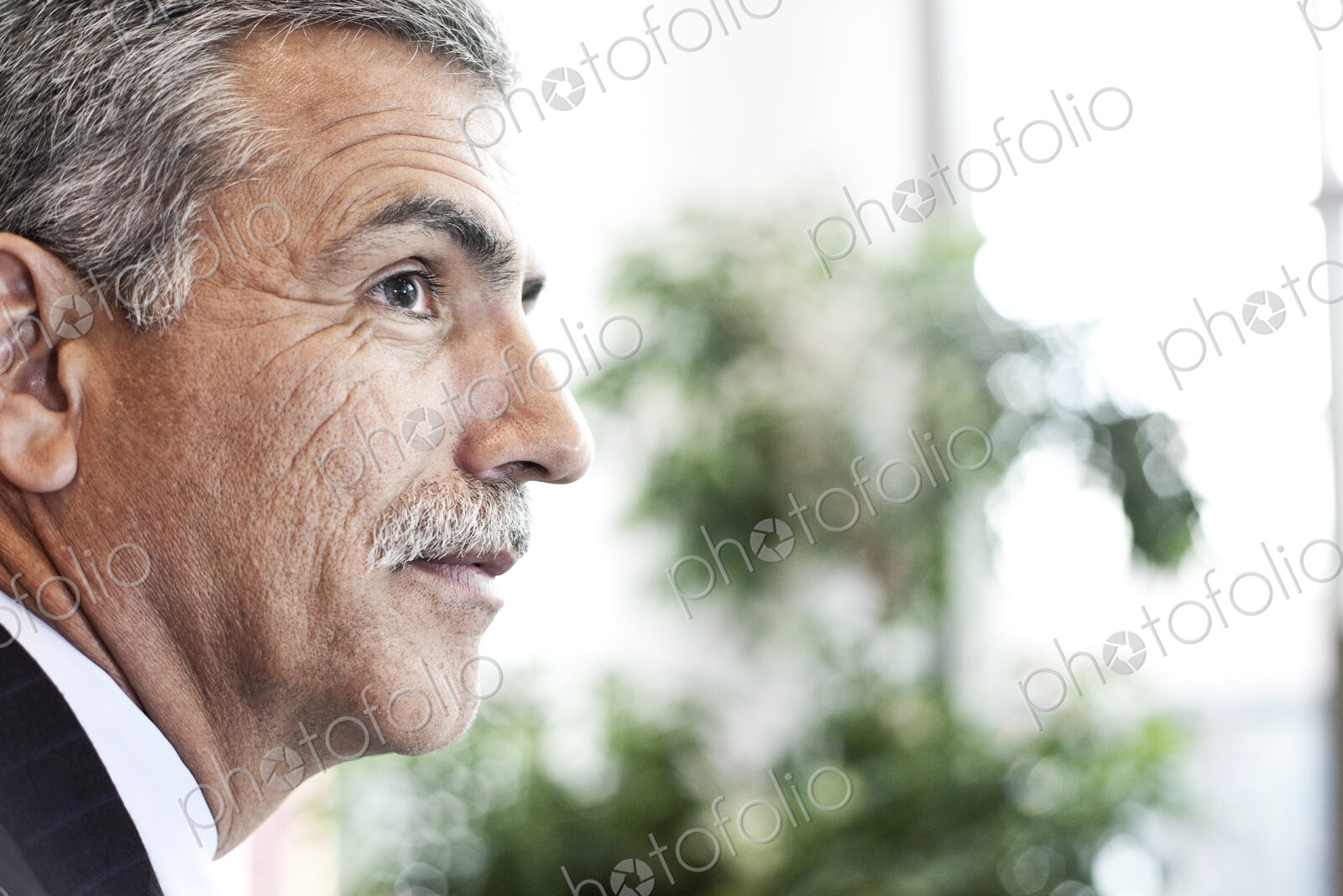 Portrait of a middle eastern businessman in an convention center lobby.