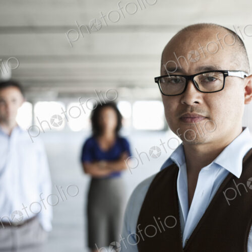Portrait of a mixed race team of business people in a new empty office space.