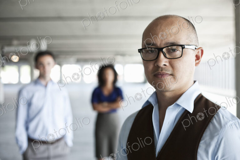 Portrait of a mixed race team of business people in a new empty office space.