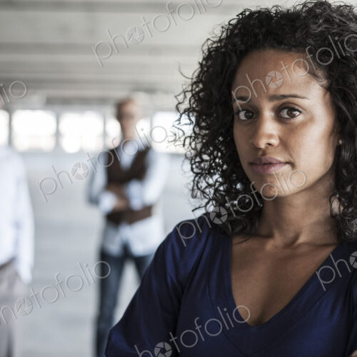 Portrait of a mixed race team of business people in a new empty office space.