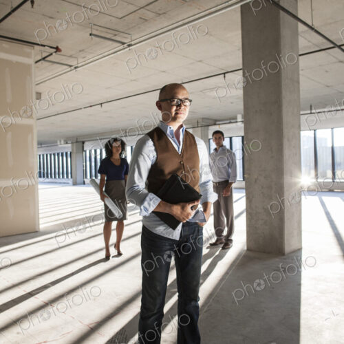 Portrait of a mixed race team of business people in a new empty office space.