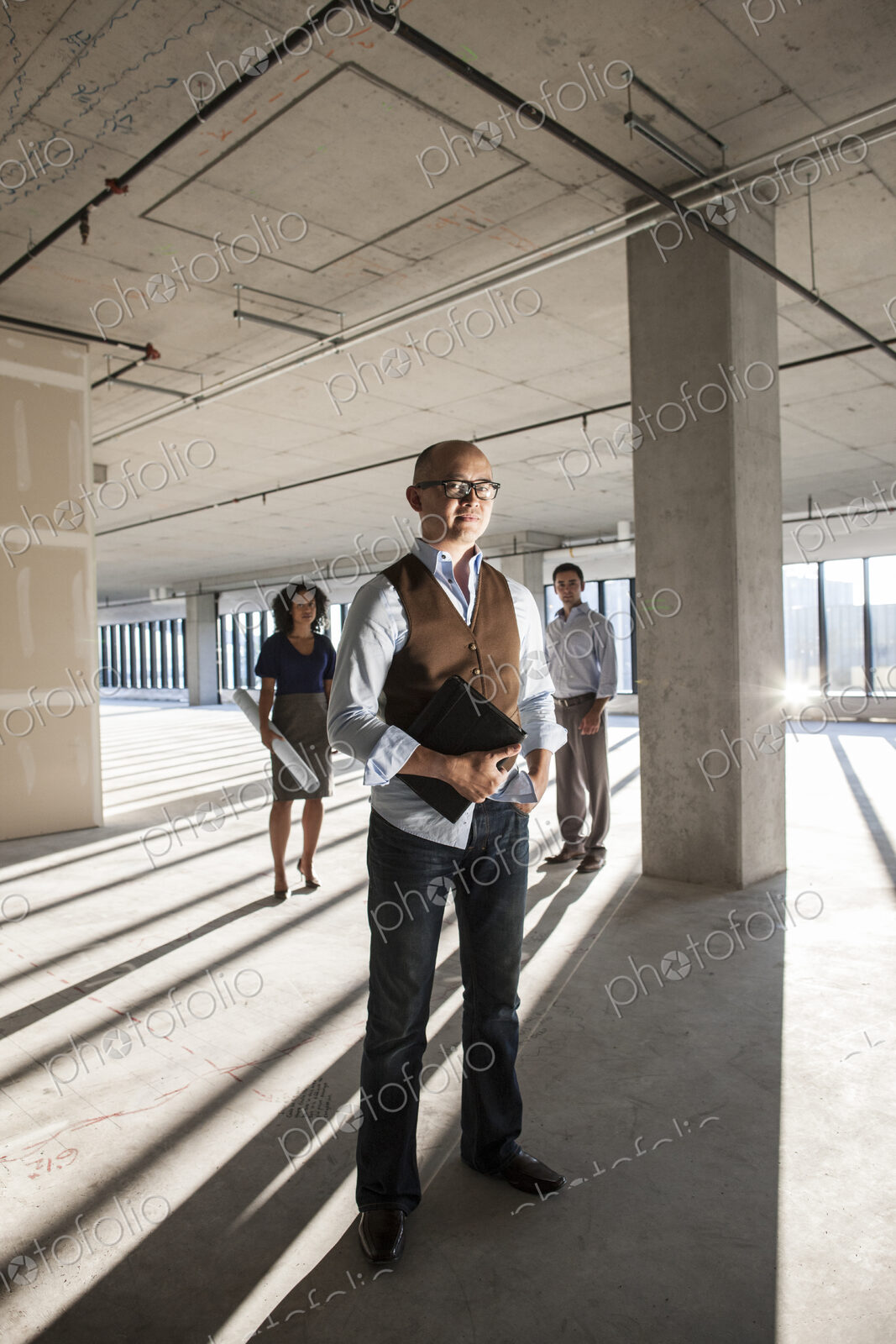 Portrait of a mixed race team of business people in a new empty office space.