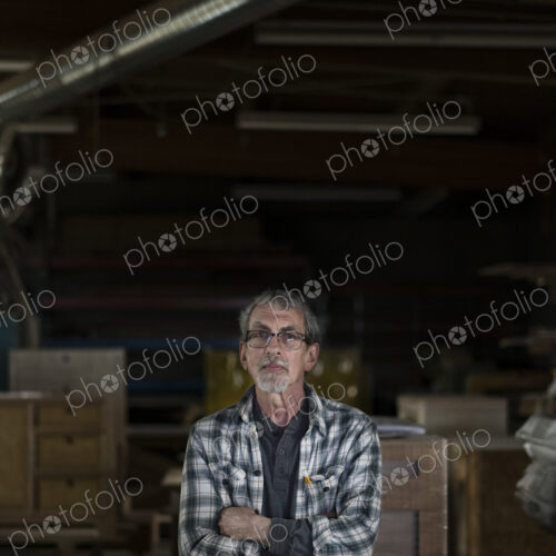 Portrait of a senior Caucasian carpenter in a large woodworking shoop. Portrait of a senior Caucasian carpenter in a large woodworking shoop.