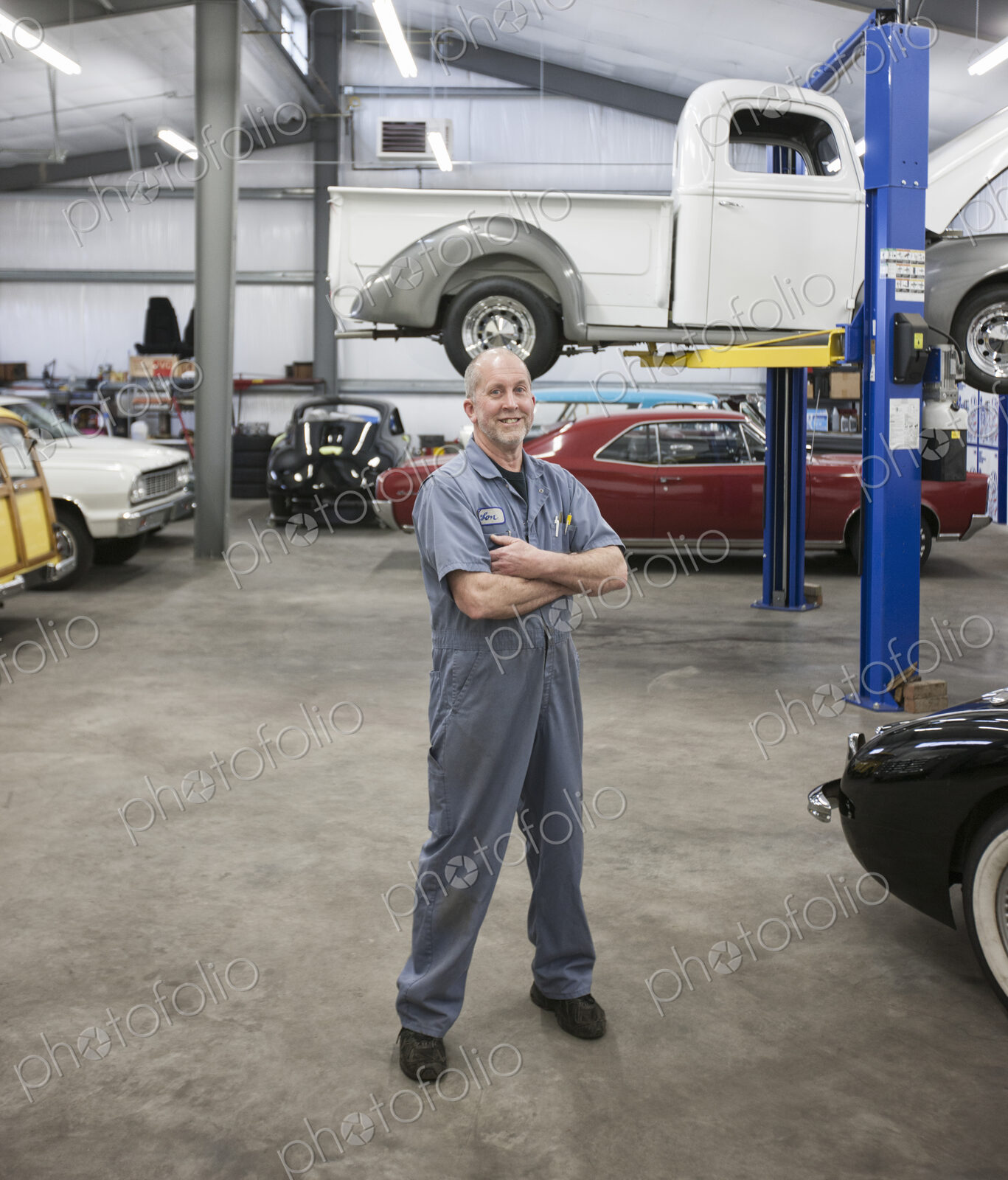 Portrait of a senior caucasian male owner of an antique car repair shop