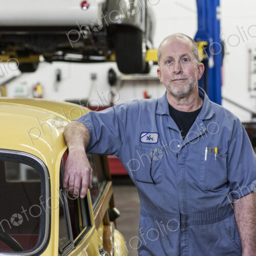 Portrait of a senior caucasian male owner of an antique car repair shop