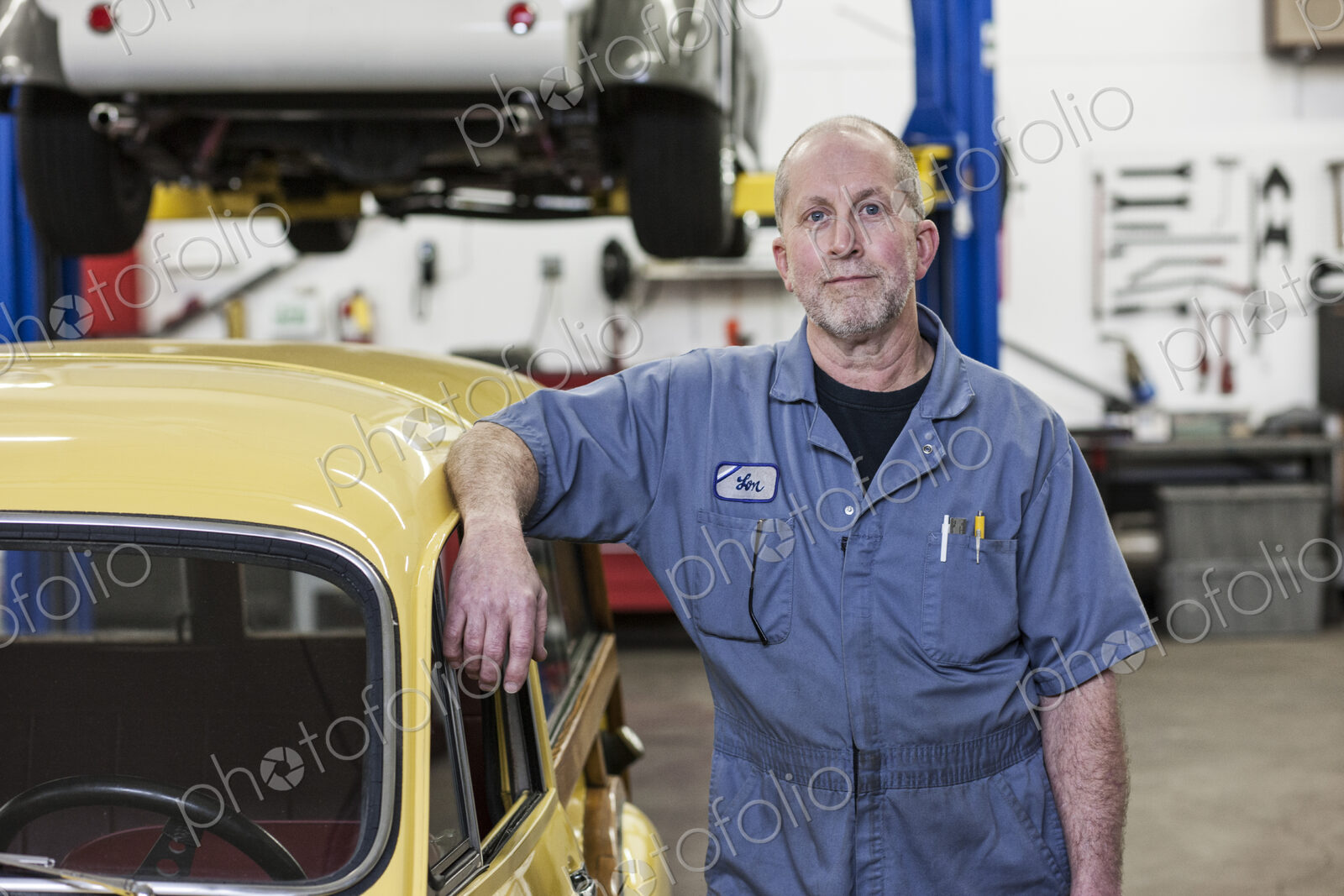 Portrait of a senior caucasian male owner of an antique car repair shop