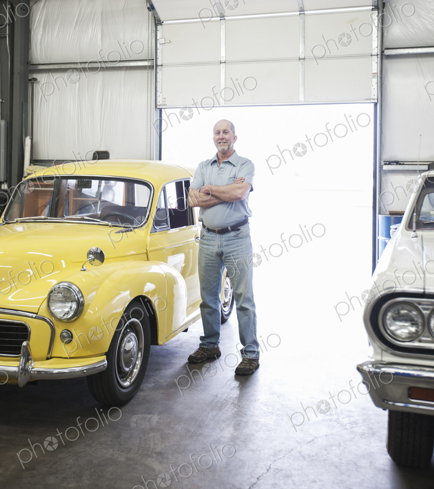Portrait of a senior caucasian male owner of an antique car repair shop
