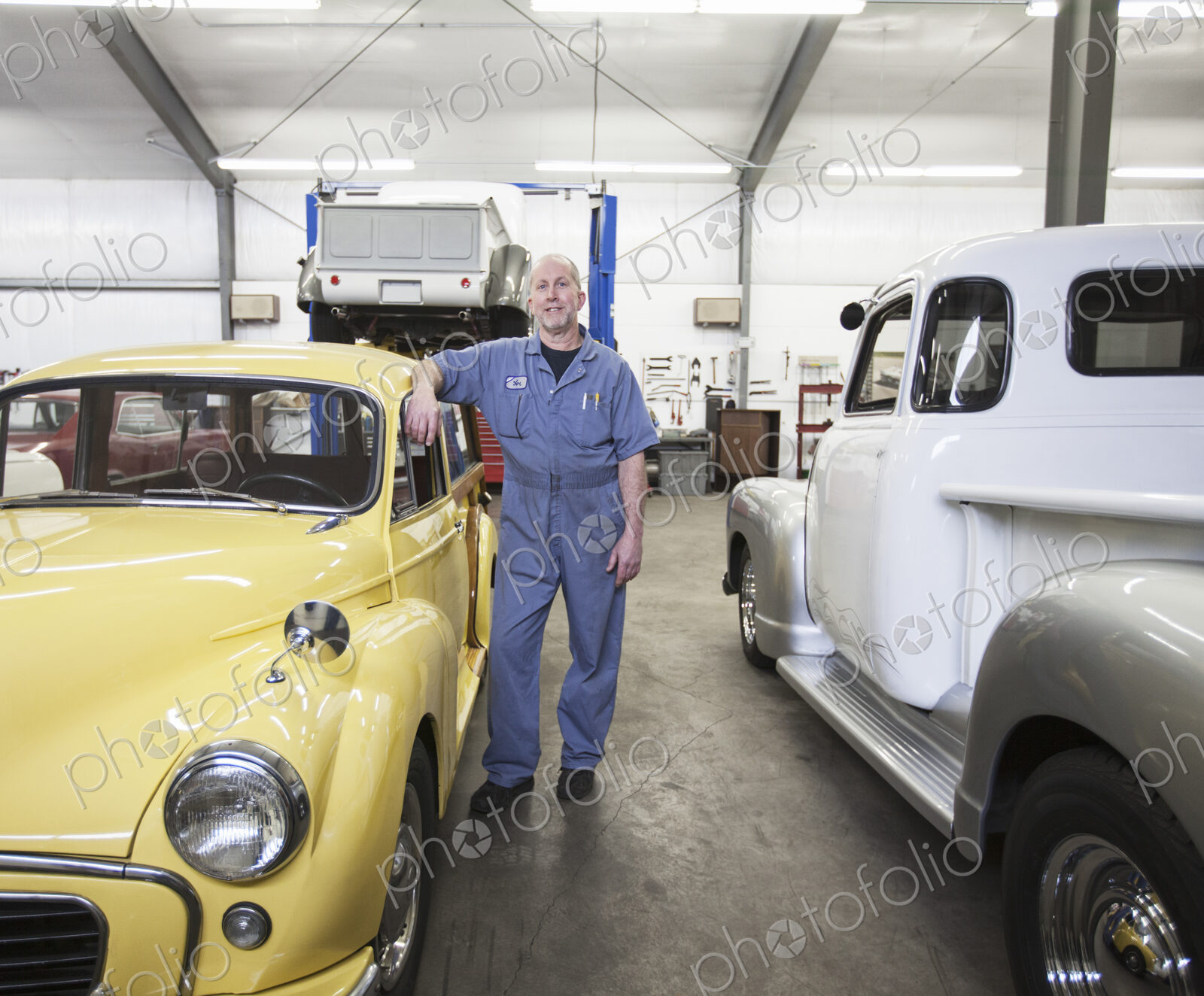 Portrait of a senior caucasian male owner of an antique car repair shop