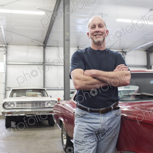 Portrait of a senior caucasian male owner of an antique car repair shop
