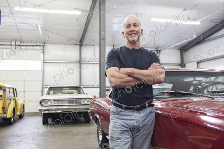 Portrait of a senior caucasian male owner of an antique car repair shop