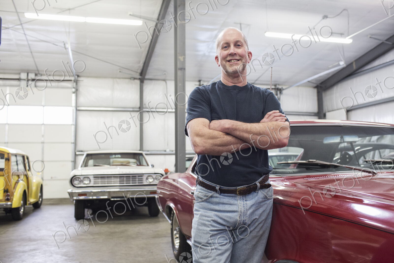 Portrait of a senior caucasian male owner of an antique car repair shop