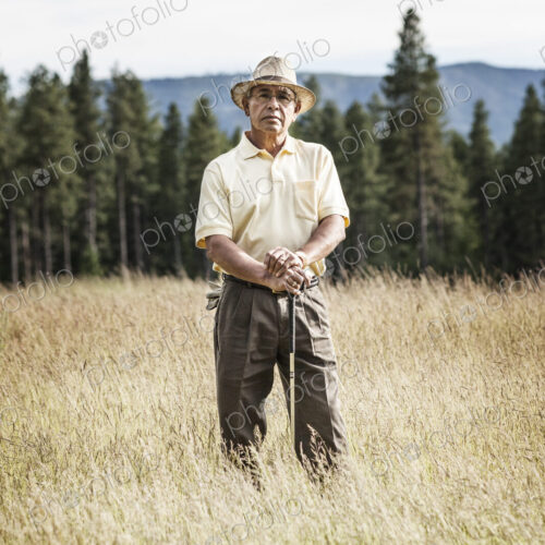 Portrait of a senior golfer standing in the heavy rough of a golf course. Portrait of a senior golfer standing in the heavy rough of a golf course.