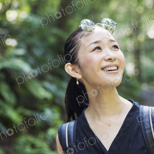 Portrait of a smiling young woman standing in a forest. Portrait of a smiling young woman standing in a forest.