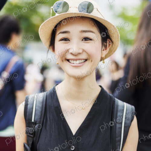 Portrait of a smiling young woman wearing a hat.