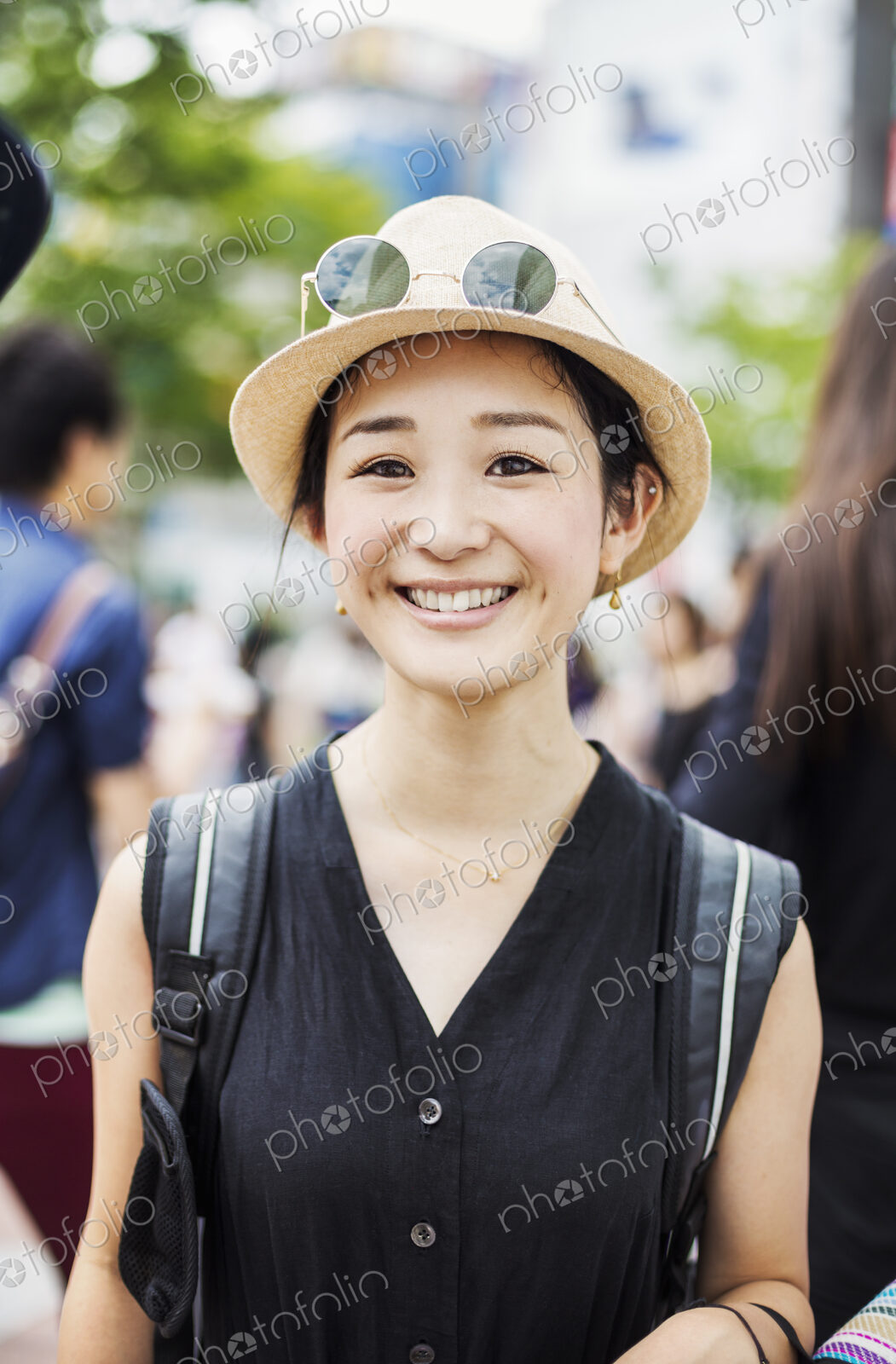 Portrait of a smiling young woman wearing a hat.