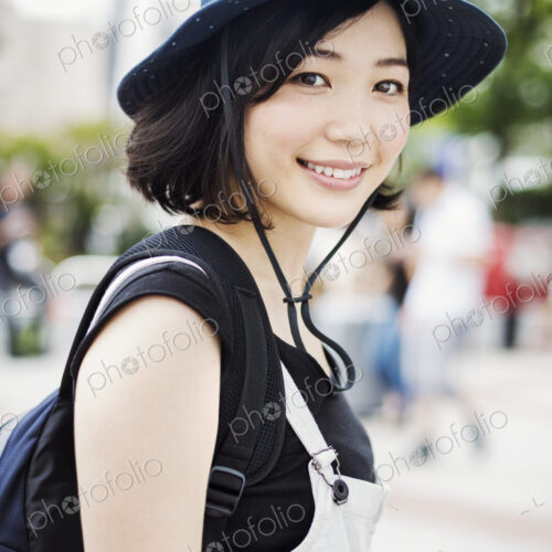Portrait of a smiling young woman wearing a hat.