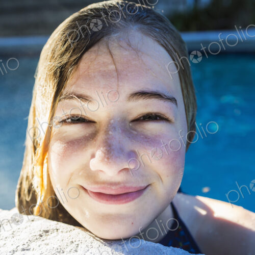 Portrait of a teenage girl in a swimming pool, head and shoulders