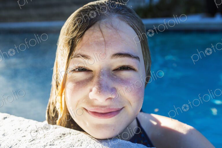 Portrait of a teenage girl in a swimming pool, head and shoulders