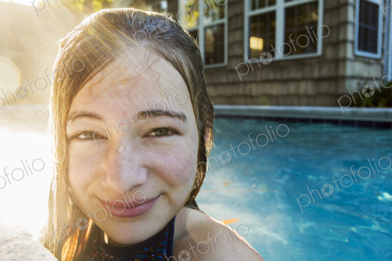 Portrait of a teenage girl in a swimming pool, head and shoulders