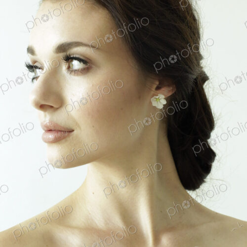 Portrait of a woman with brown hair tied in an elegant bun. Portrait of a woman with brown hair tied in an elegant bun.