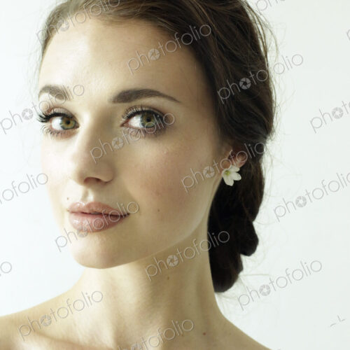 Portrait of a woman with brown hair tied in an elegant bun. Portrait of a woman with brown hair tied in an elegant bun.
