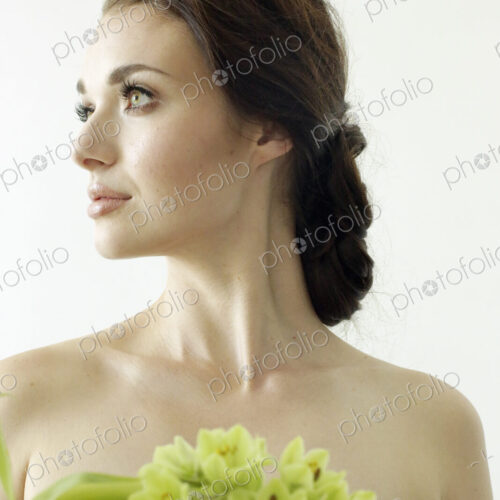 Portrait of a woman with brown hair tied in an elegant bun, wearing a dress with a… Portrait of a woman with brown hair tied in an elegant bun, wearing a dress with a…