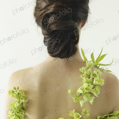 Portrait of a woman with brown hair tied in an elegant bun, wearing a dress with a… Portrait of a woman with brown hair tied in an elegant bun, wearing a dress with a…