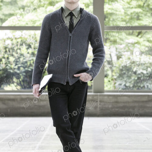 Portrait of a young hip geek businesman holding a notebook computer. Portrait of a young hip geek businesman holding a notebook computer.