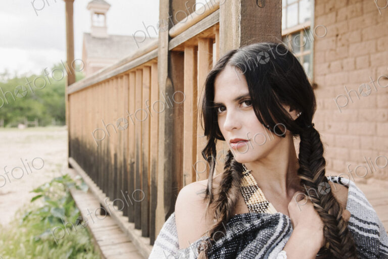 Portrait of a young woman with long brown hair in braids.