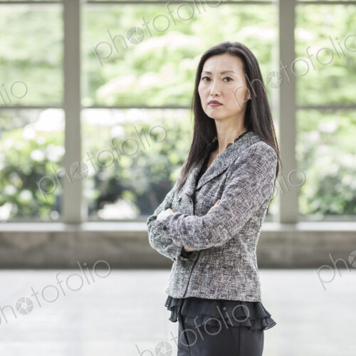 Portrait of an Asian businesswoman in the lobby of a convention center. Portrait of an Asian businesswoman in the lobby of a convention center.