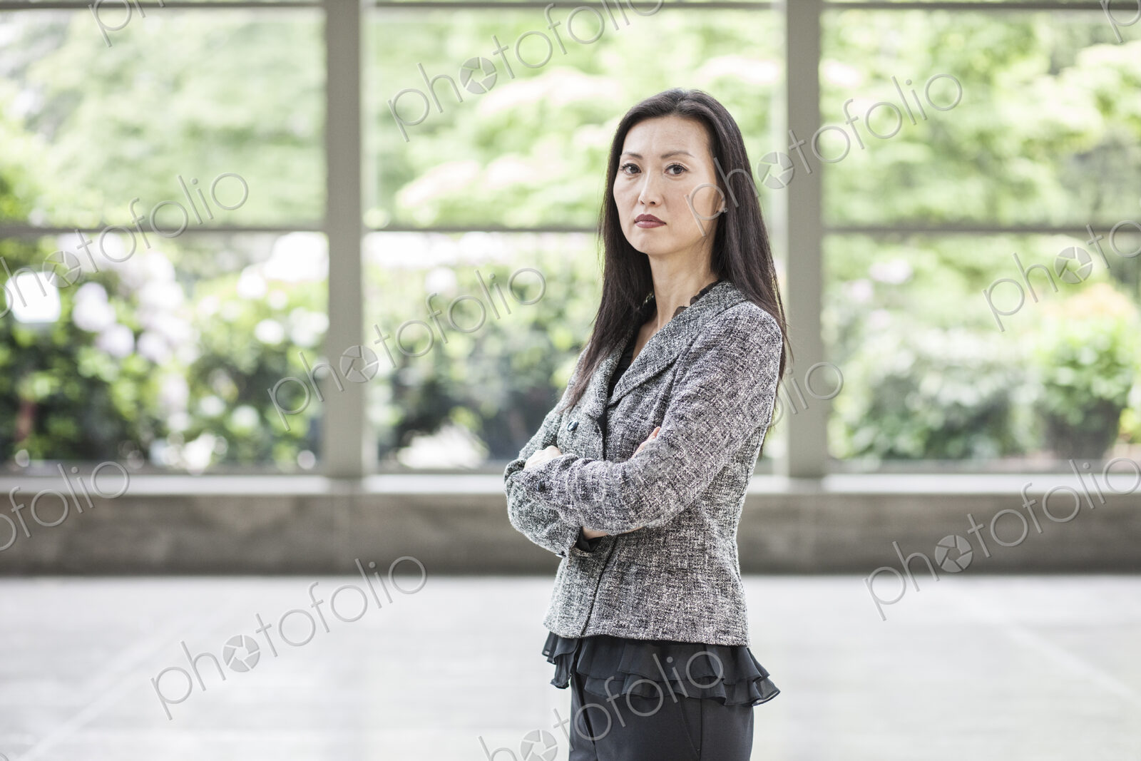 Portrait of an Asian businesswoman in the lobby of a convention center.