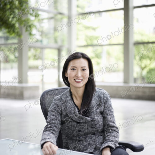 Portrait of an Asian businesswoman in the lobby of a convention center. Portrait of an Asian businesswoman in the lobby of a convention center.