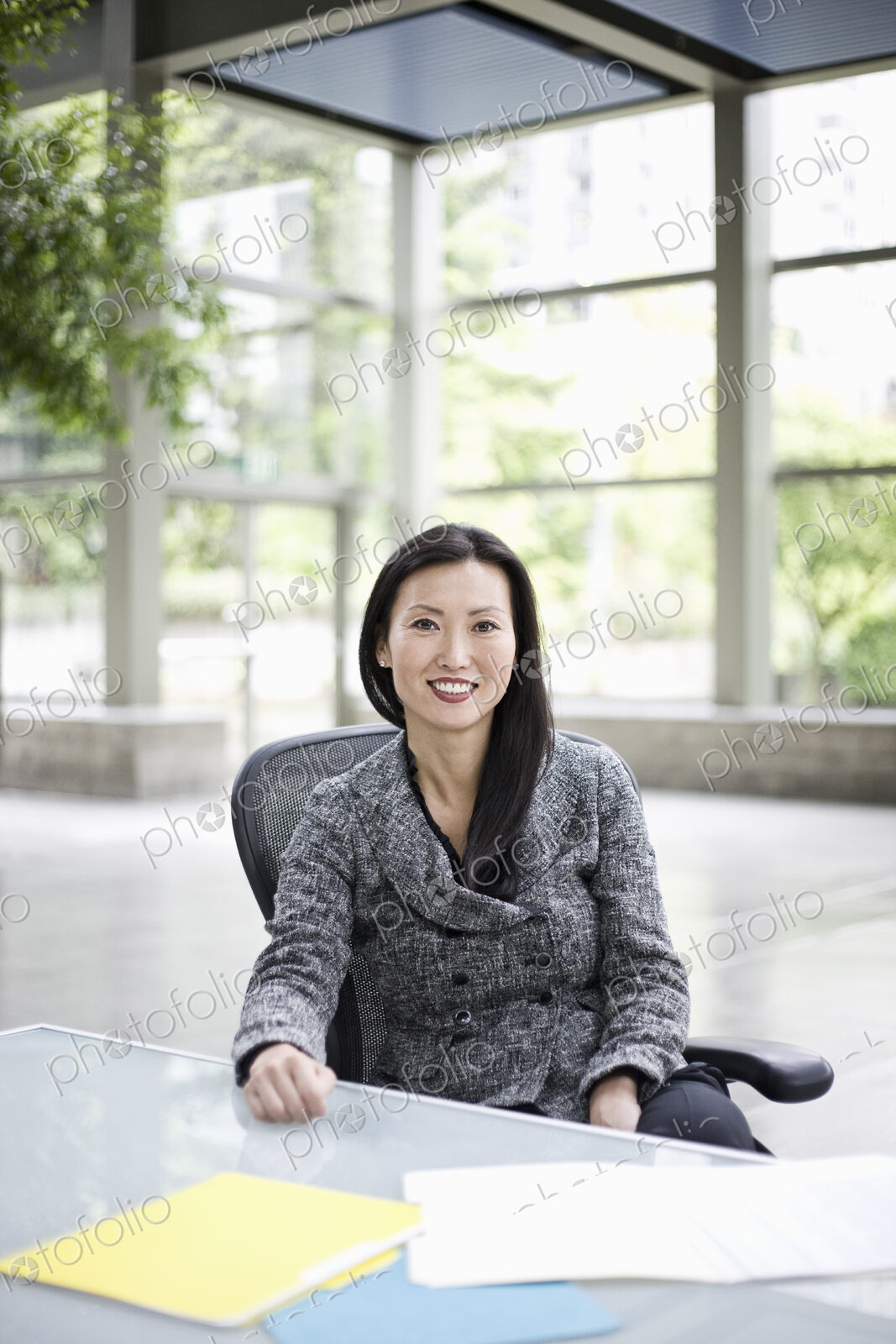Portrait of an Asian businesswoman in the lobby of a convention center.