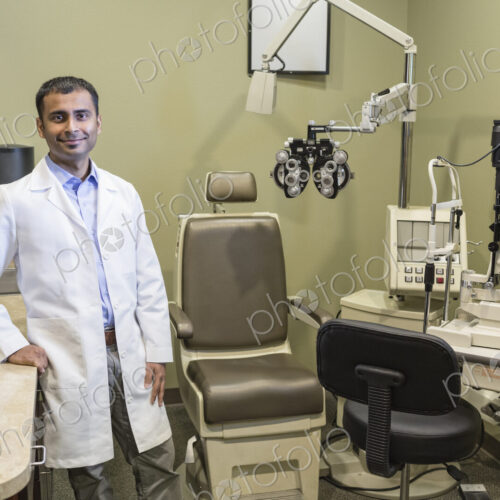 Portrait of an east Indian male ophthalmologist in his examination office. Portrait of an east Indian male ophthalmologist in his examination office.