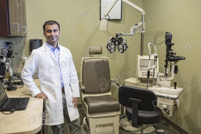 Portrait of an east Indian male ophthalmologist in his examination office.