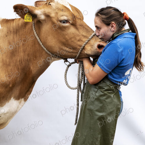 Portrait of female farmer wearing green apron with a Guernsey cow. Portrait of female farmer wearing green apron with a Guernsey cow.