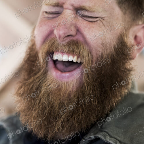 Portrait of laughing bearded man with light brown hair. Portrait of laughing bearded man with light brown hair.