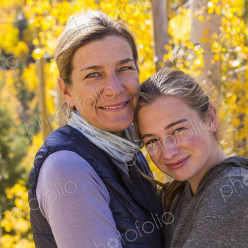 Portrait of mother and her 13 year old daughter with autumn aspens in background Portrait of mother and her 13 year old daughter with autumn aspens in background
