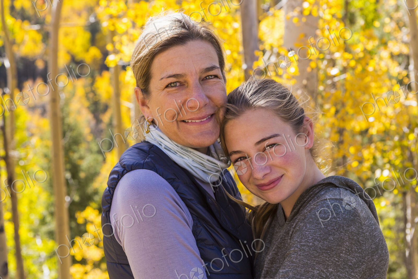 Portrait of mother and her 13 year old daughter with autumn aspens in background
