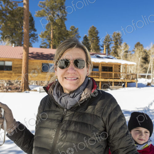 Portrait of mother and her young son outdoors in snow