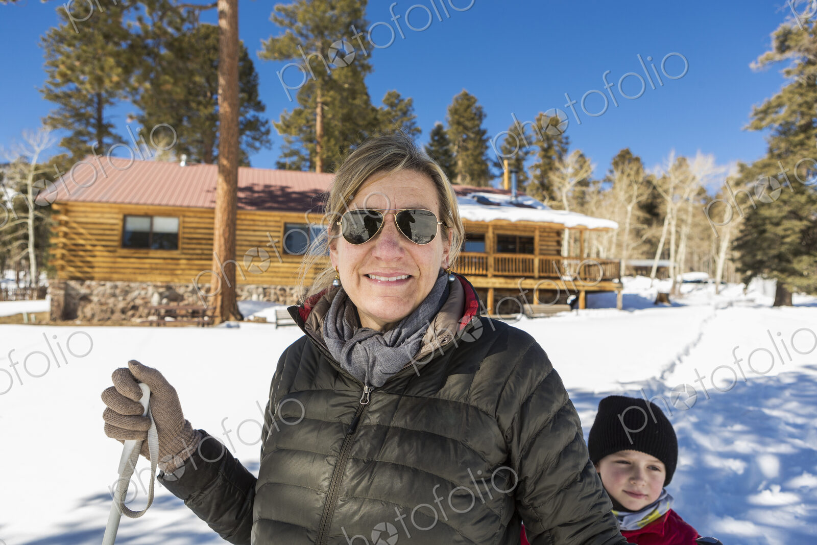 Portrait of mother and her young son outdoors in snow