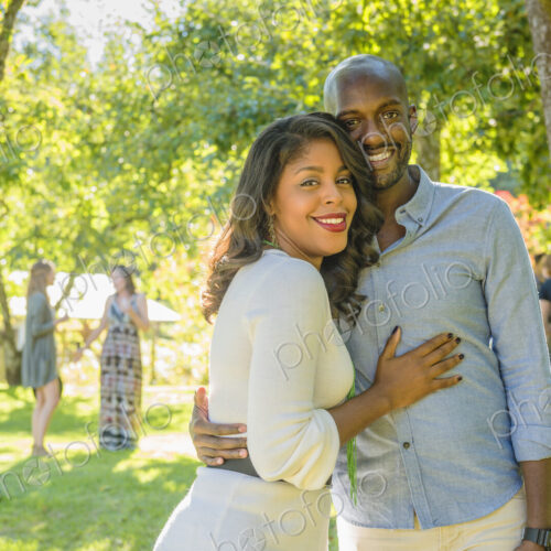 Portrait of smiling African American couple hugging outdoors Portrait of smiling African American couple hugging outdoors
