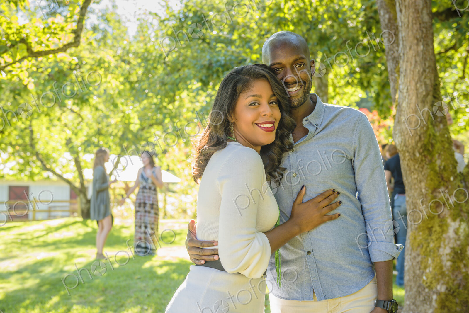 Portrait of smiling African American couple hugging outdoors