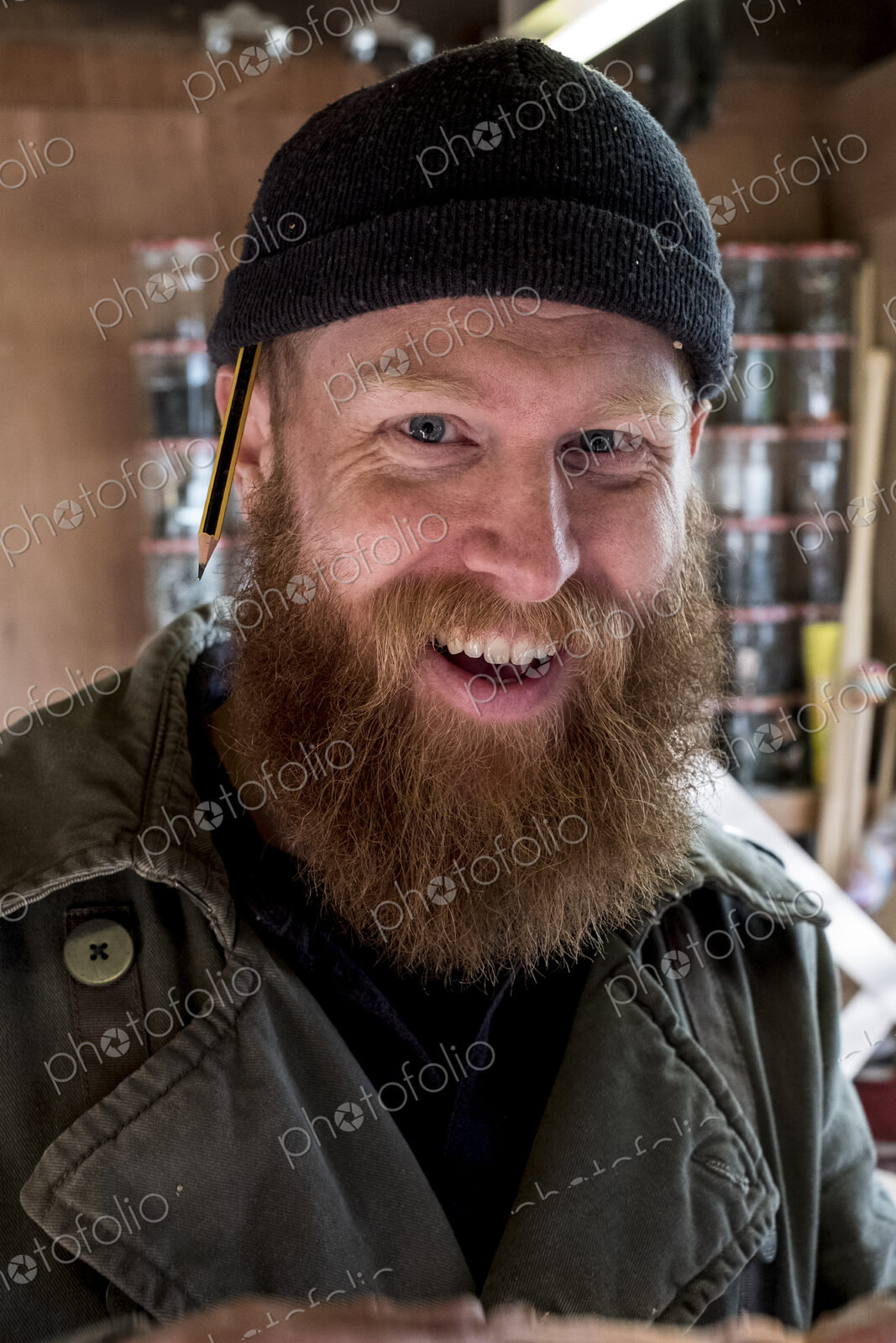 Portrait of smiling bearded man with light brown hair, wearing black beanie.