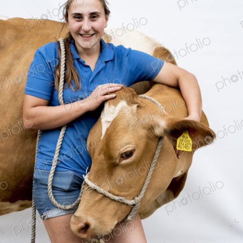Portrait of smiling female farmer with a Guernsey cow. Portrait of smiling female farmer with a Guernsey cow.